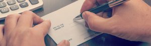 man writing out a check